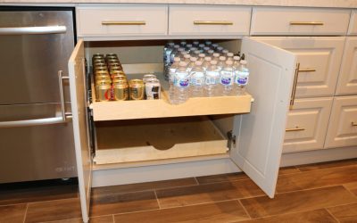 custom pull out shelf in kitchen stocked with beverages