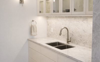 A bright, organized master‑bedroom closet featuring clean white shelving, baskets, and a polished storage layout.