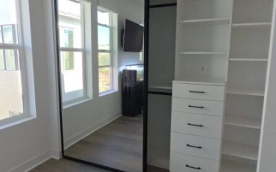 A modern, minimal closet layout with open shelving and hanging space designed for efficient organization.