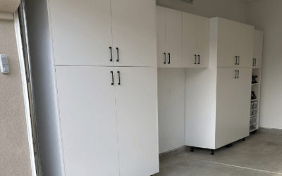 Modern garage setup featuring elevated white cabinets and open floor space for efficient organization.