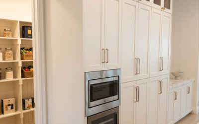 Contemporary kitchen with full‑height white cabinetry, built‑in appliances, and a spacious walk‑in pantry.