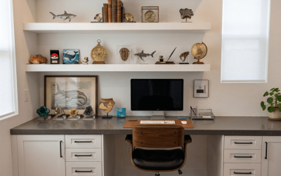 Home office setup with white built‑ins, open shelving, and a streamlined workspace for productivity and display.